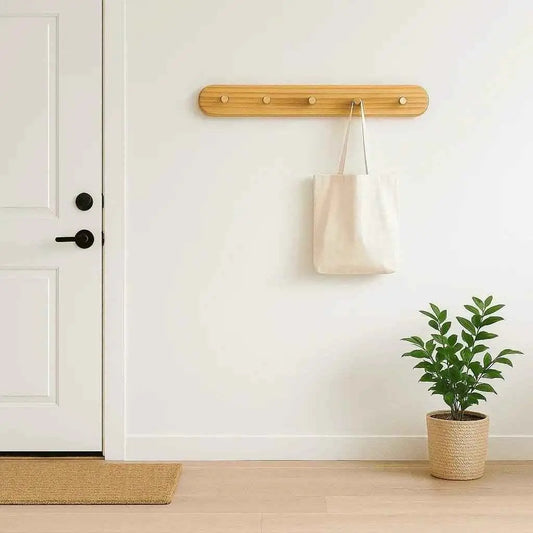 Pine hook rack mounted in an entryway beside the front door holding a canvas tote bag