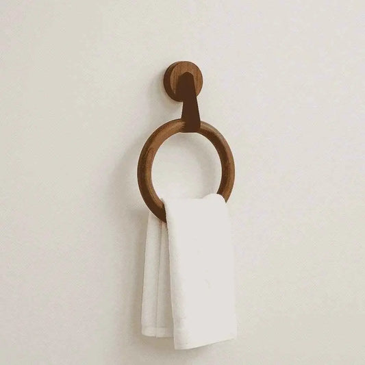 Rosewood towel ring on a plain cream wall with a folded white towel draped through it
