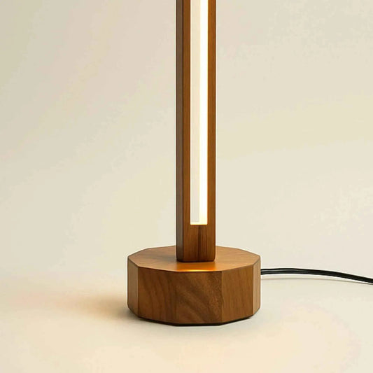 Close-up of the octagonal wooden base and hollow LED rod of the compact table lamp