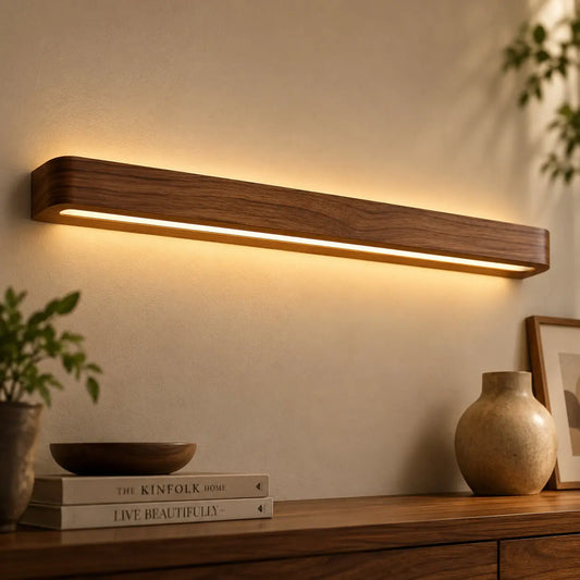 Angled view of the teak linear wall light showing its depth and the recessed warm LED channel underneath