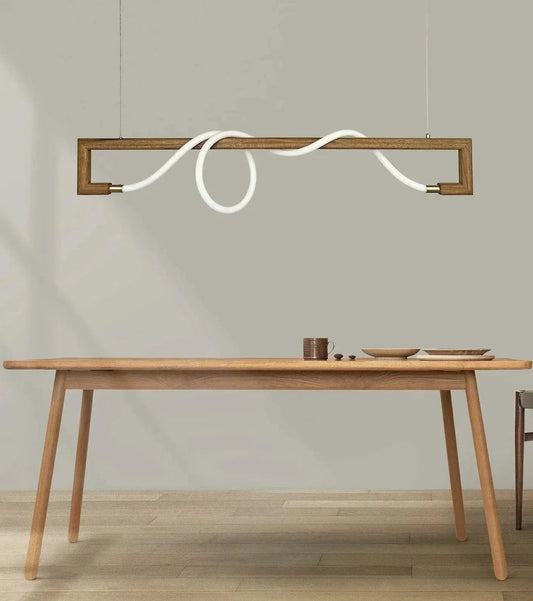 Rosewood frame pendant with looped silicone LED tube hung above a pale wood dining table