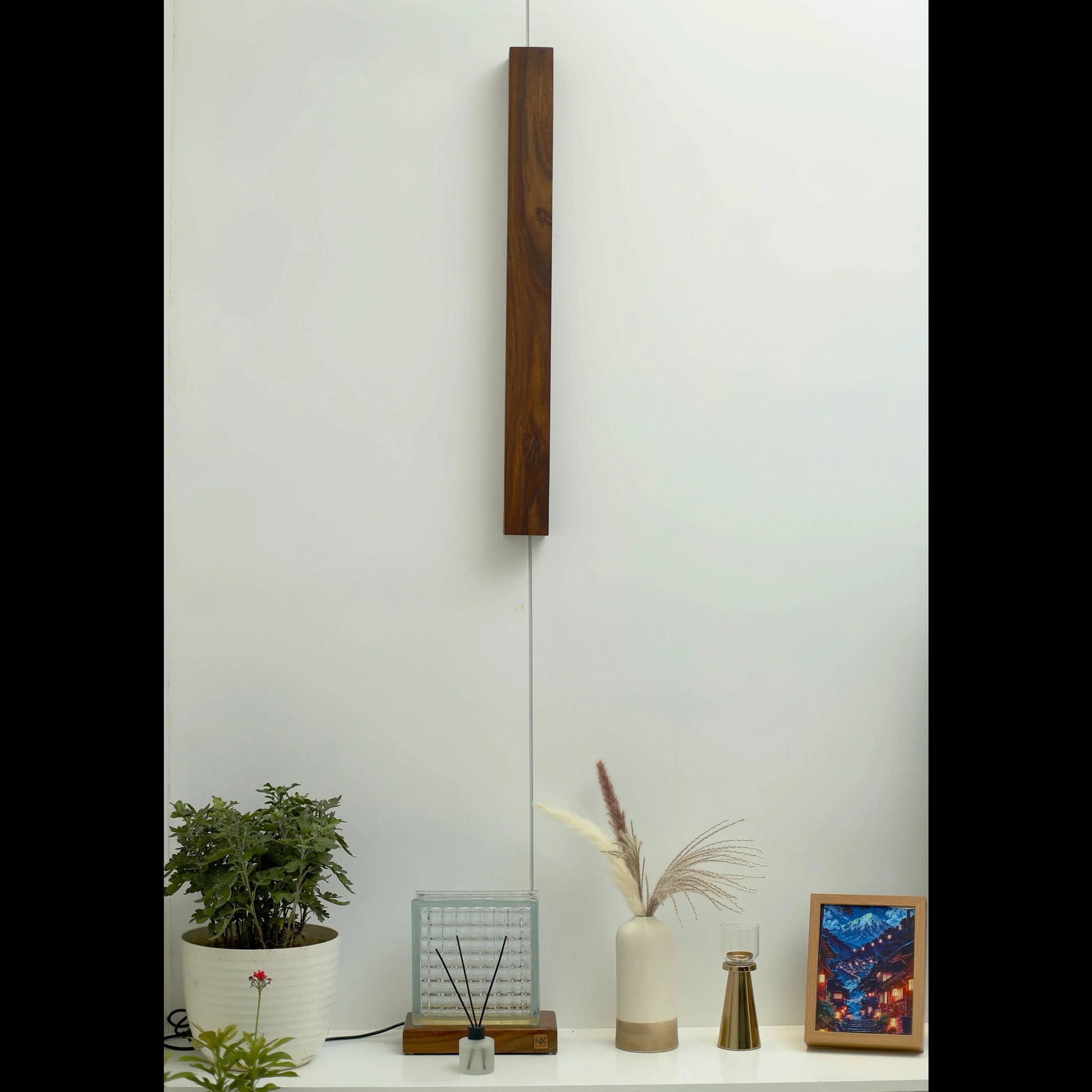 Nix Line dark wood wall light above a console with plants and decor - NixWoods vertical wall sconce