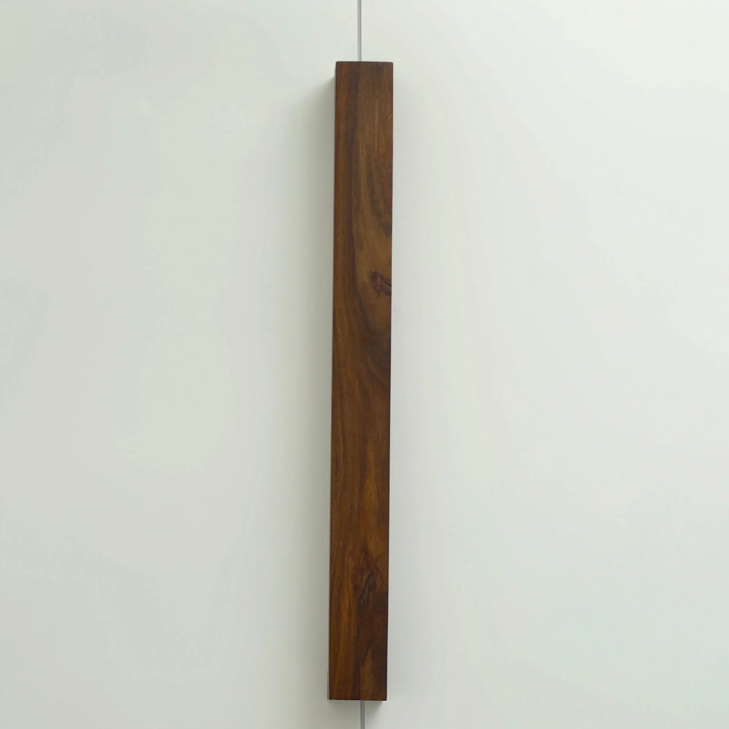 Nix Line vertical wall light in dark solid wood on a pale wall - NixWoods handcrafted wall sconce