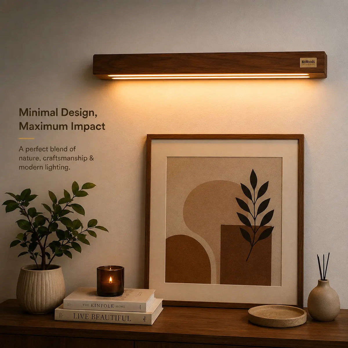 Sheesham wall light glowing above a framed print on a sideboard with candle and books