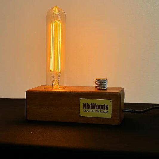 Wooden lamp base with a lit bulb and 'NixWoods' label on a dark background