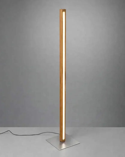 Scandinavian Teak Linear Floor Lamp against a grey studio wall, warm LED running the full height of the solid teak column