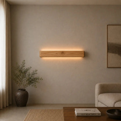 Pine linear LED wall light in a neutral living room with sofa and framed art
