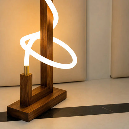 Close-up of the LED tube looping the rosewood frame with its brass end fitting