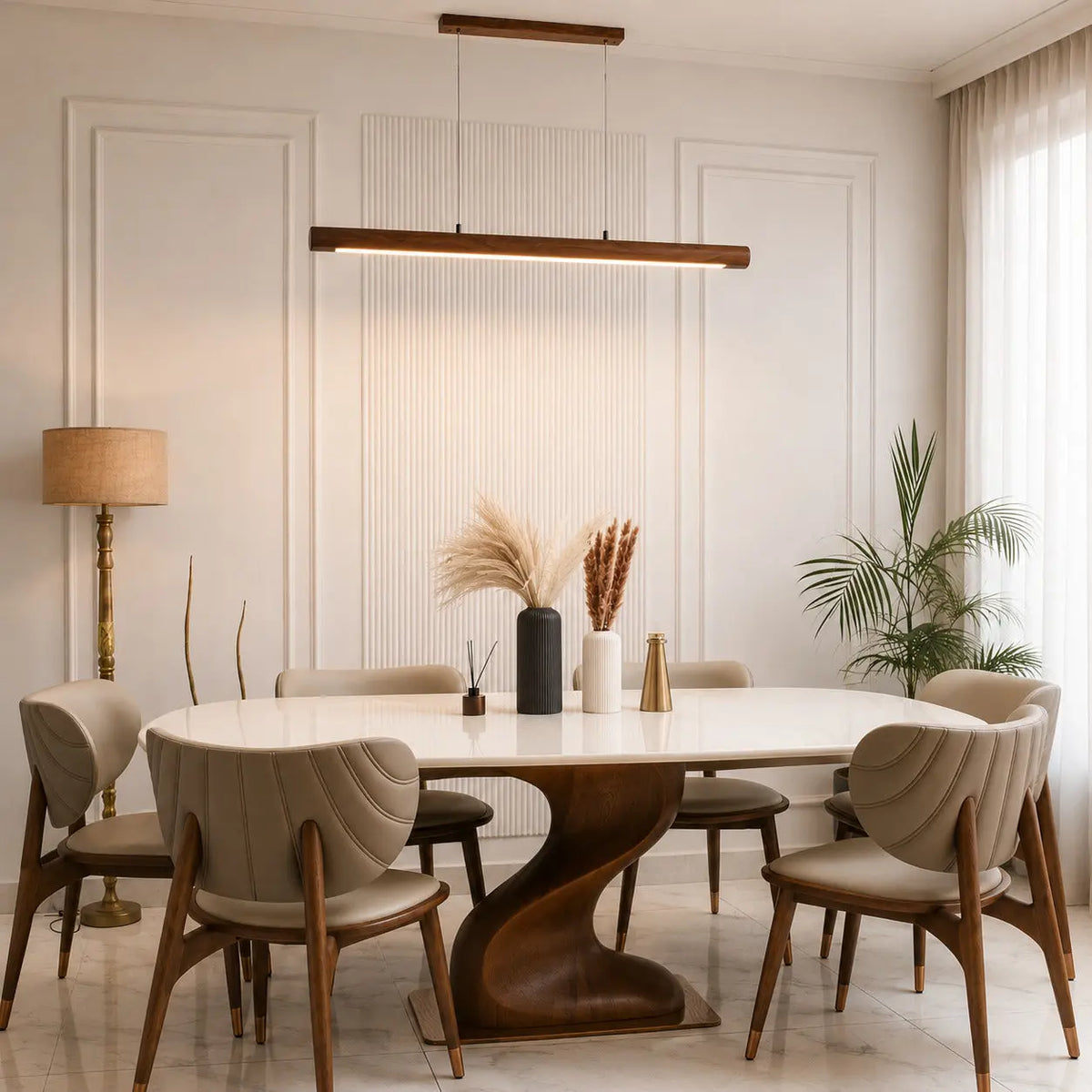 Rosewood cylindrical pendant in daylight over an oval dining table with sculpted chairs
