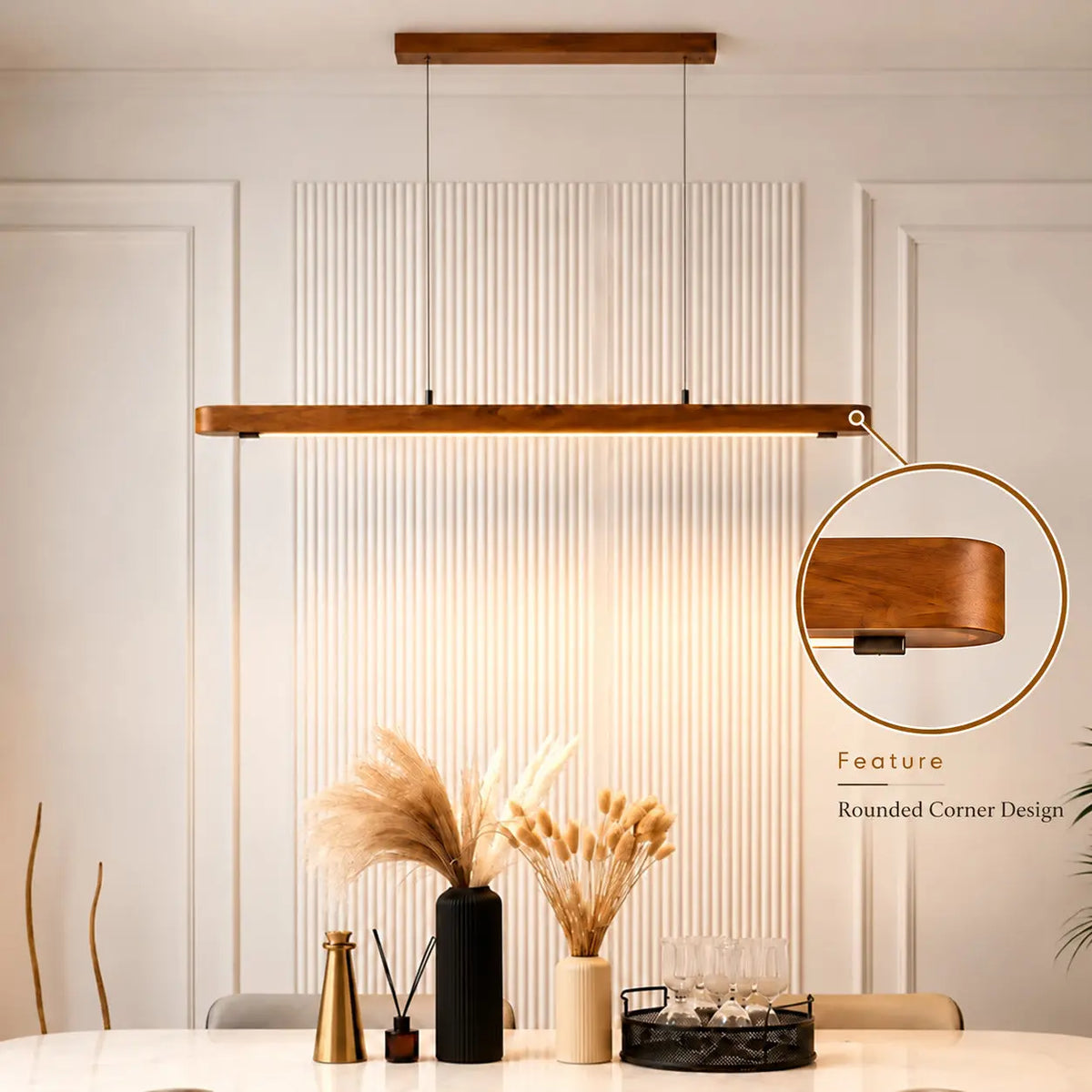 Nordic teak linear pendant light over a white dining table with pampas grass, rounded corner callout