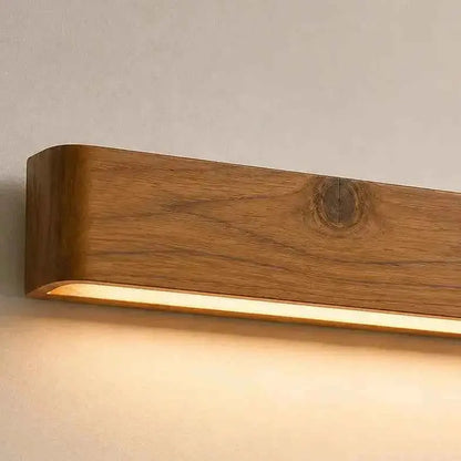 Aure solid teak linear LED wall light close-up showing the grain and a knot, NixWoods