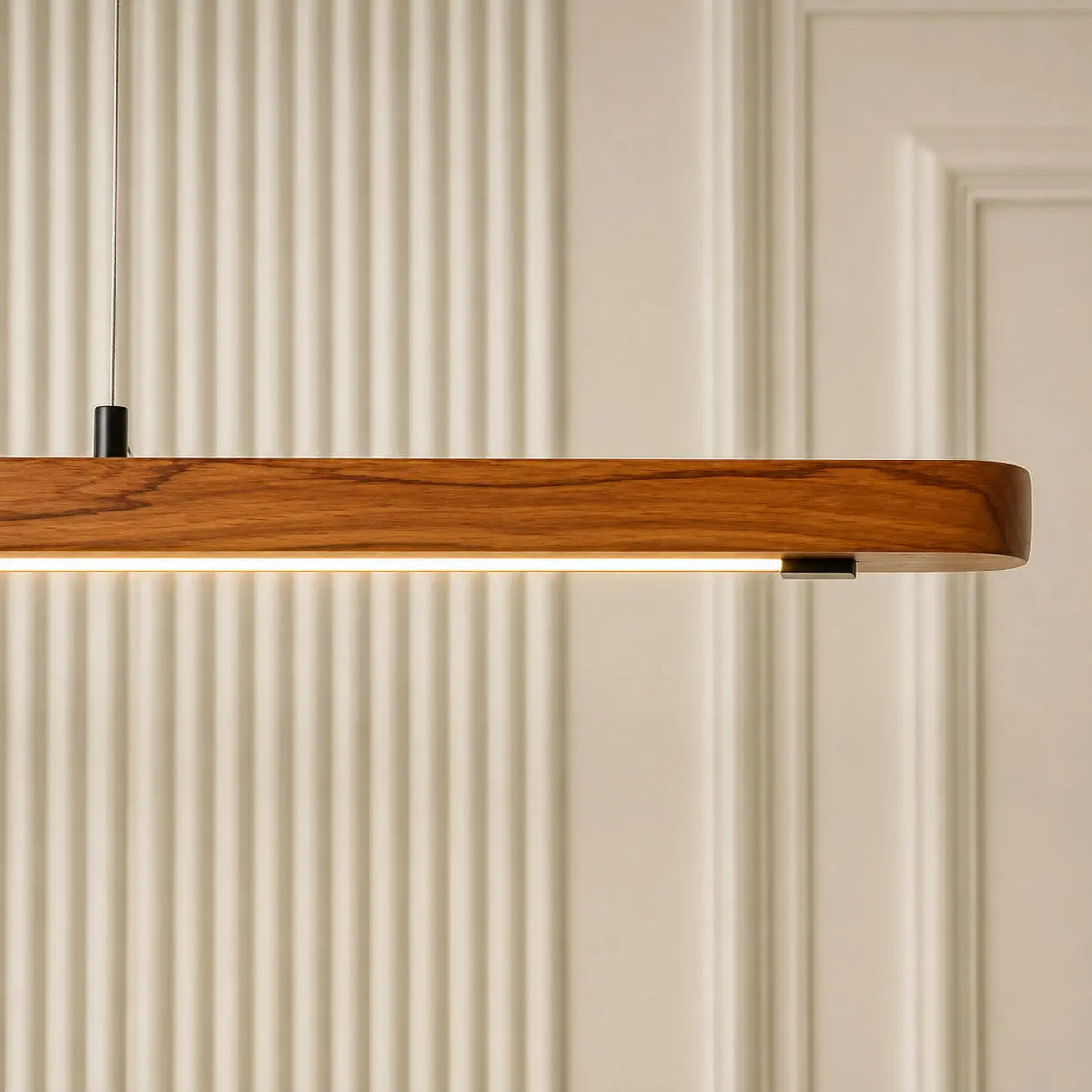Close-up of the rounded teak end of the linear pendant with its warm LED channel underneath