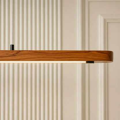 Close-up of the rounded teak end of the linear pendant with its warm LED channel underneath