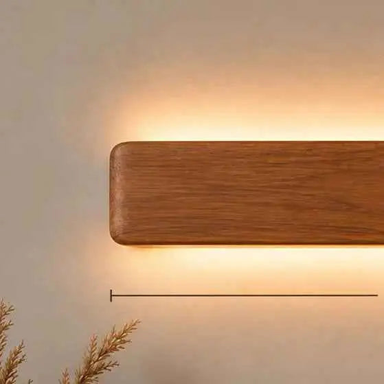 Angled view of the Arden 14-inch rosewood wall light casting light up and down the wall