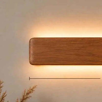 Angled view of the Arden 14-inch rosewood wall light casting light up and down the wall