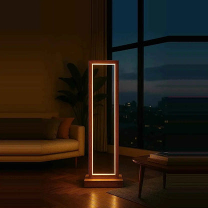 Teak rectangular floor lamp glowing at night beside a sofa and city-view window