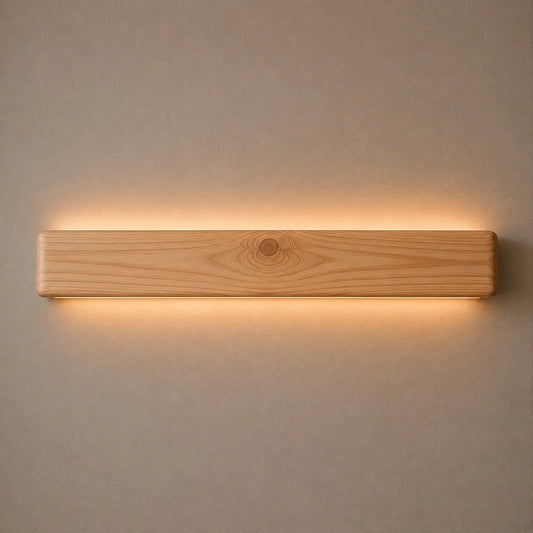 Pine Nix Line 30-inch linear LED wall light glowing warm white on a plain wall
