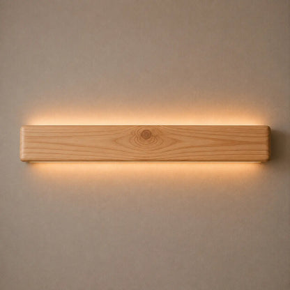 Pine Nix Line 30-inch linear LED wall light glowing warm white on a plain wall