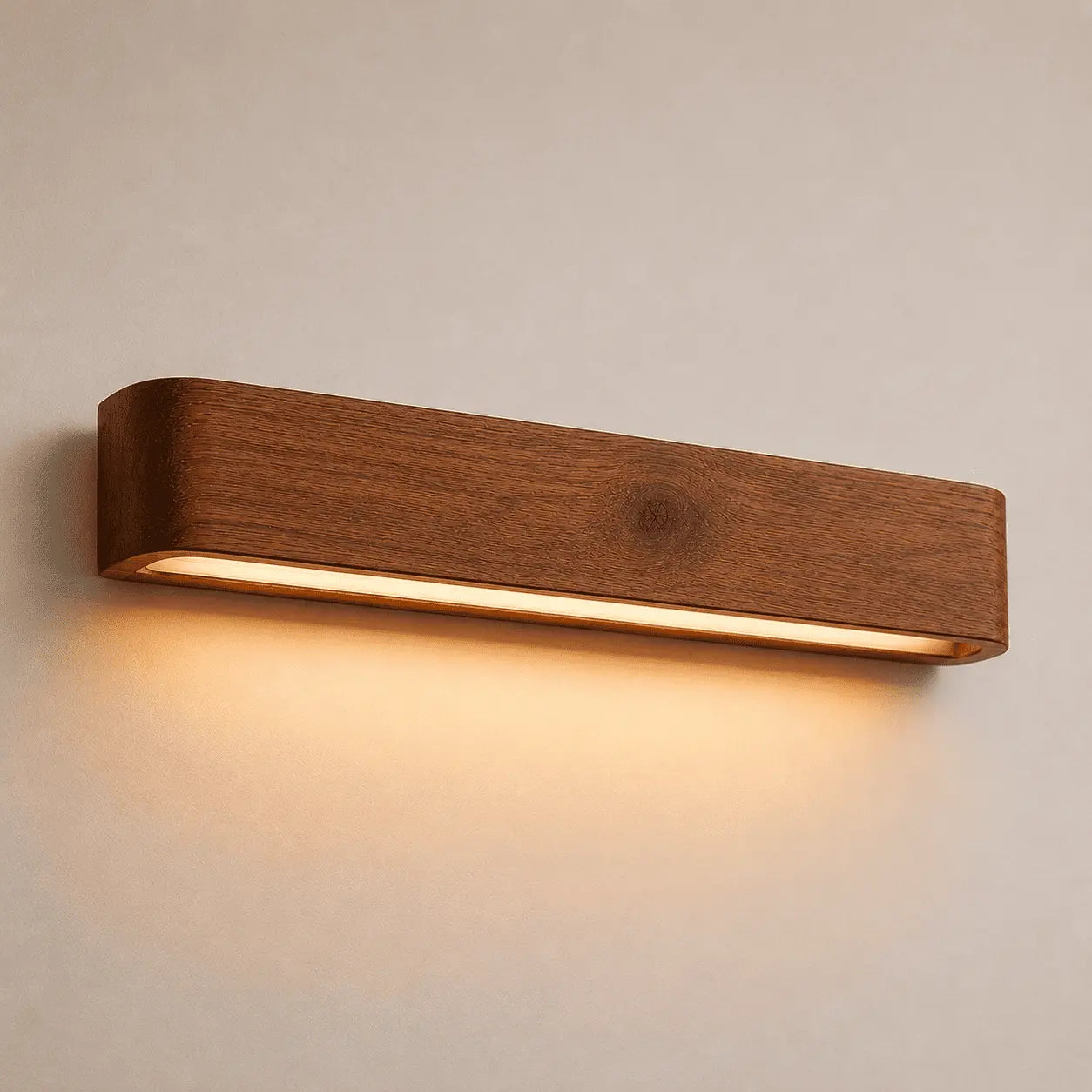 Aure indirect wall light in solid wood, angled body with a warm LED strip beneath