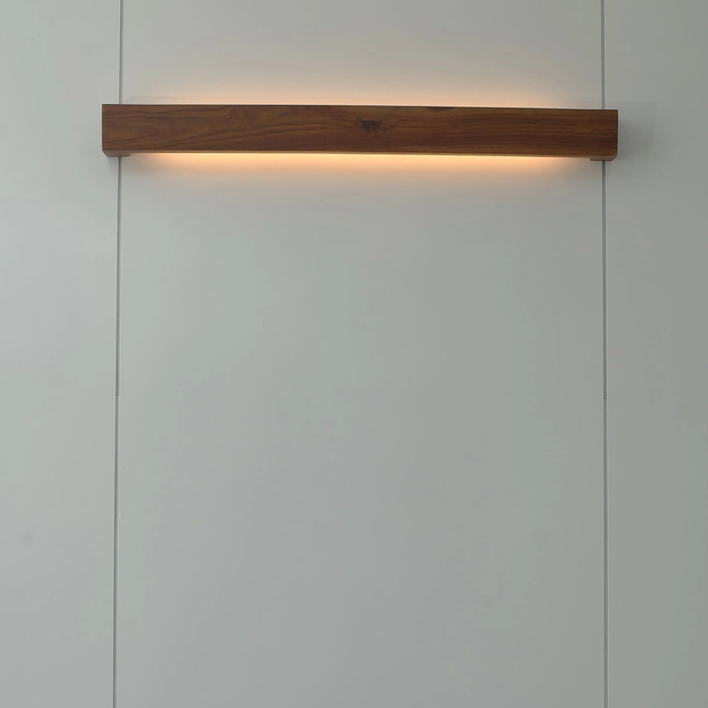 Nix Line solid wood wall light mounted horizontally and lit warm - NixWoods wooden wall sconce