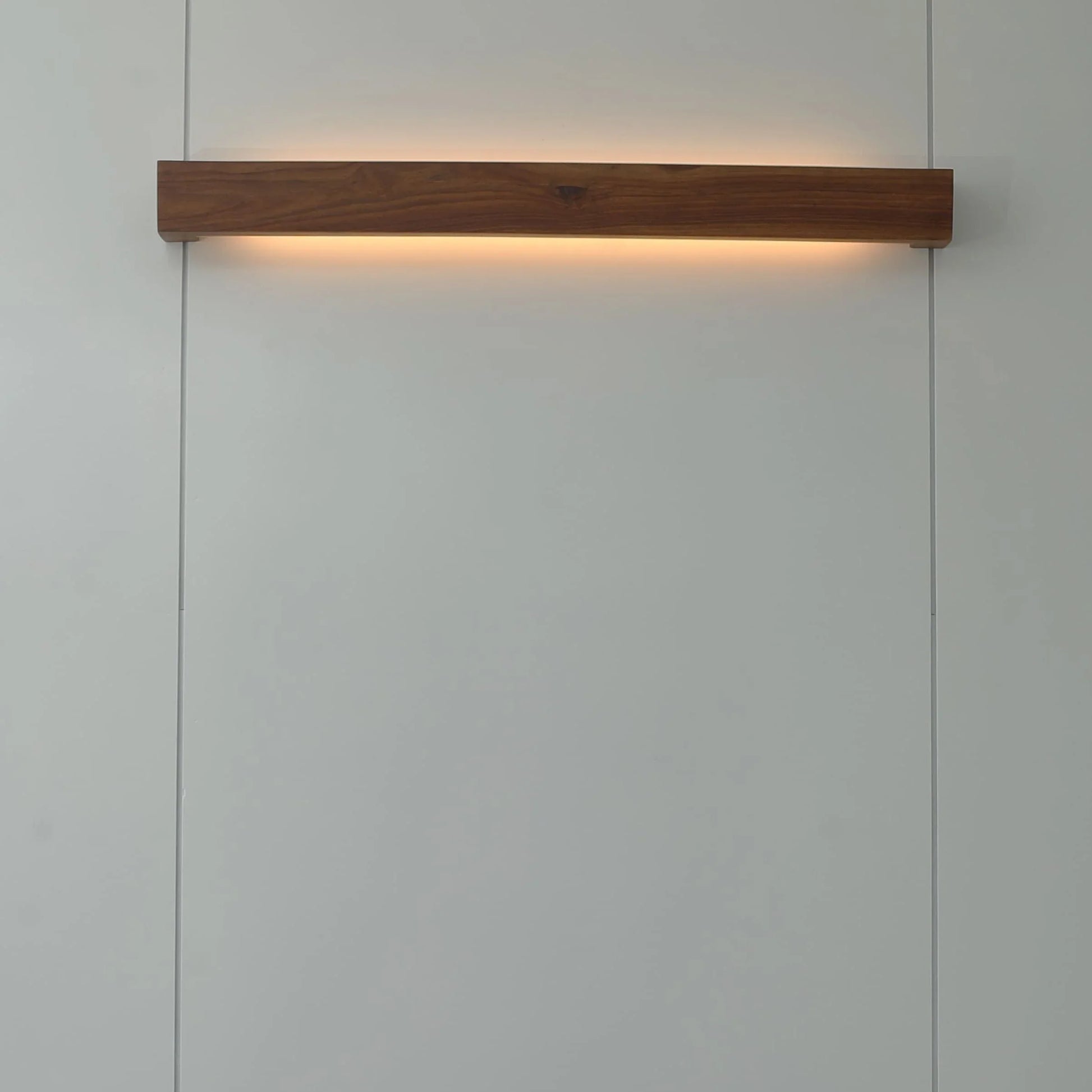 Nix Line solid wood wall light mounted horizontally and lit warm - NixWoods wooden wall sconce