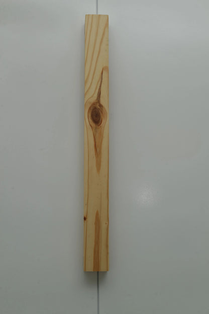 Nix Line vertical wall light in pale solid wood on a plain wall - NixWoods handcrafted wall sconce