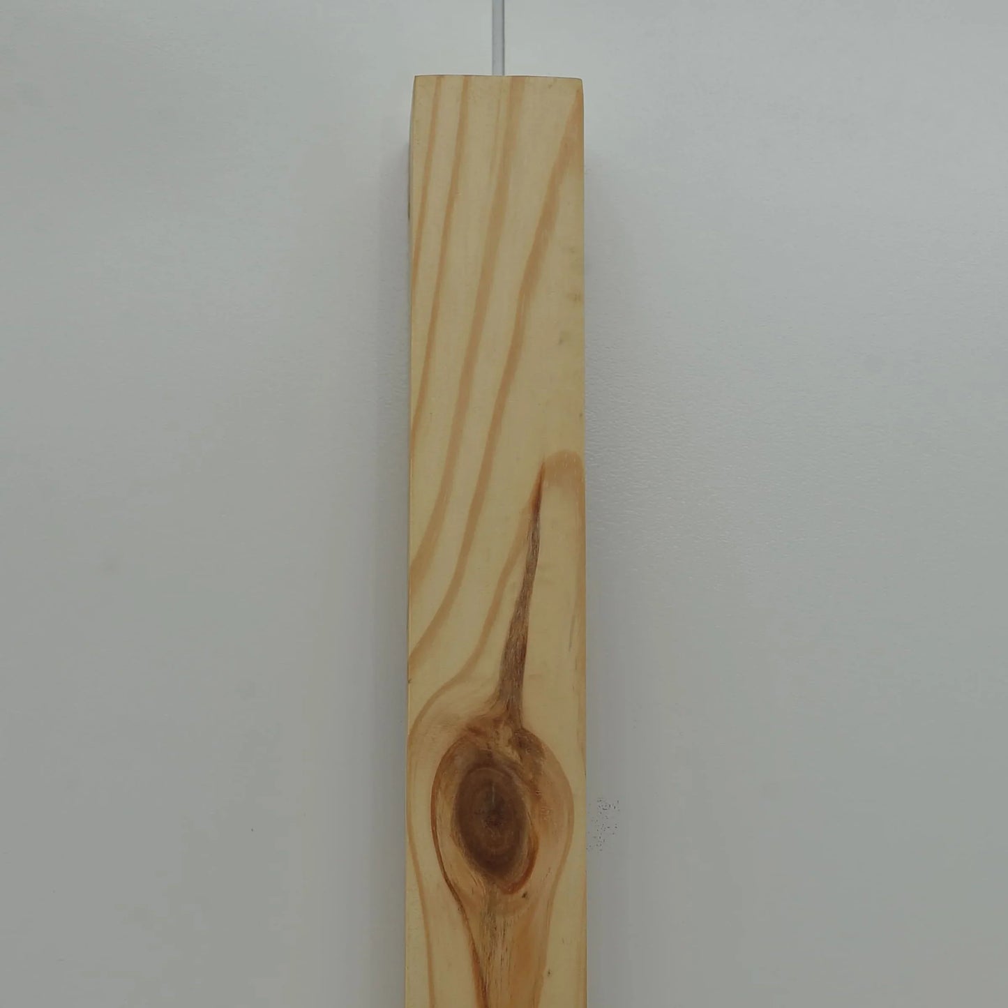 Close view of the natural grain and knot in the Nix Line solid wood wall light - NixWoods sconce