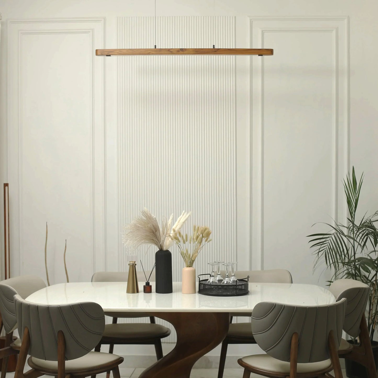 Teak linear pendant light above a styled dining table with plants - NixWoods hanging light