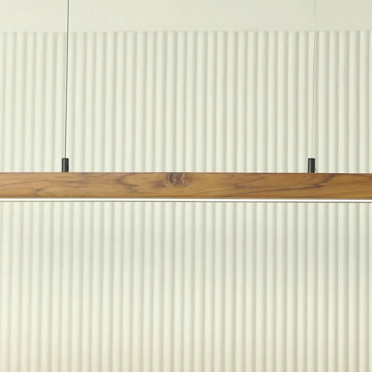 Teak pendant light bar mounted low against a fluted wall - NixWoods wooden hanging light