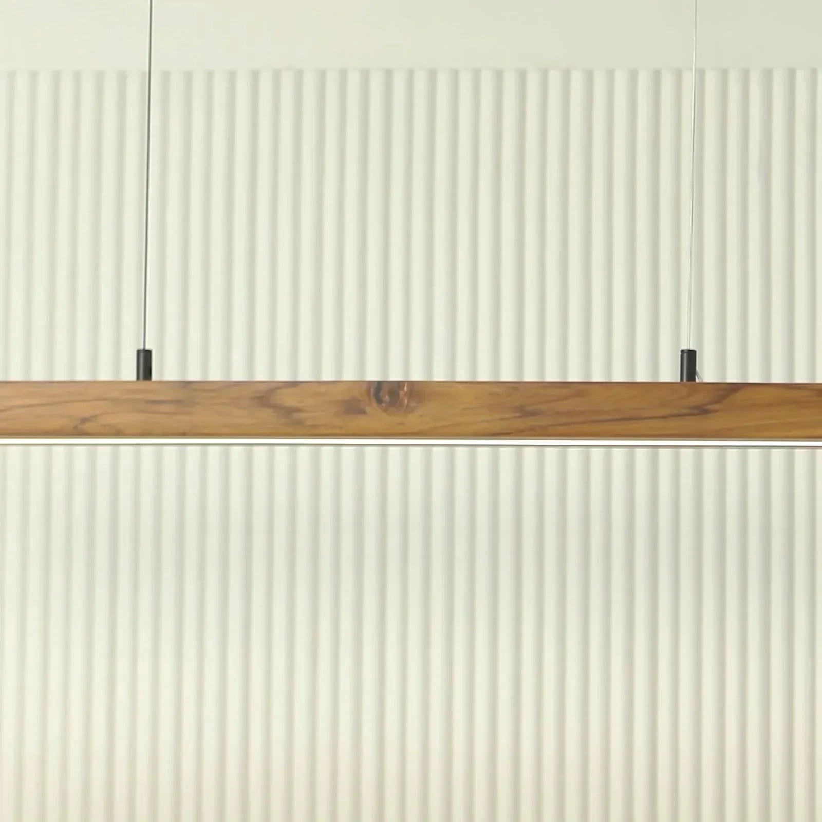 Teak pendant light bar mounted low against a fluted wall - NixWoods wooden hanging light
