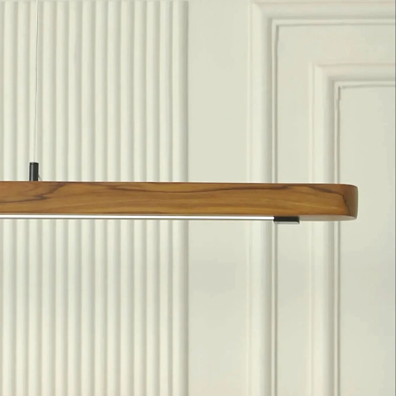 Close view of the solid teak pendant light body and grain - NixWoods linear hanging light