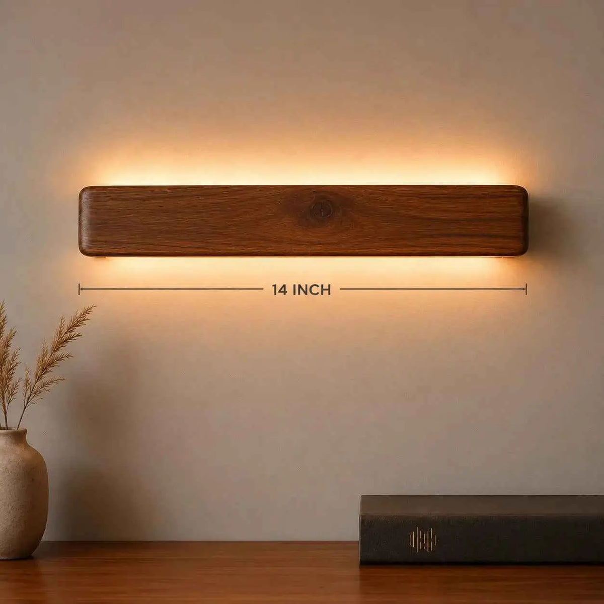 Arden rosewood up down wall light with its 14-inch length marked, above a sideboard