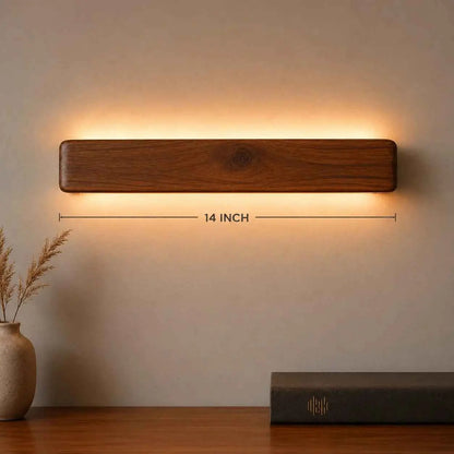 Arden rosewood up down wall light with its 14-inch length marked, above a sideboard