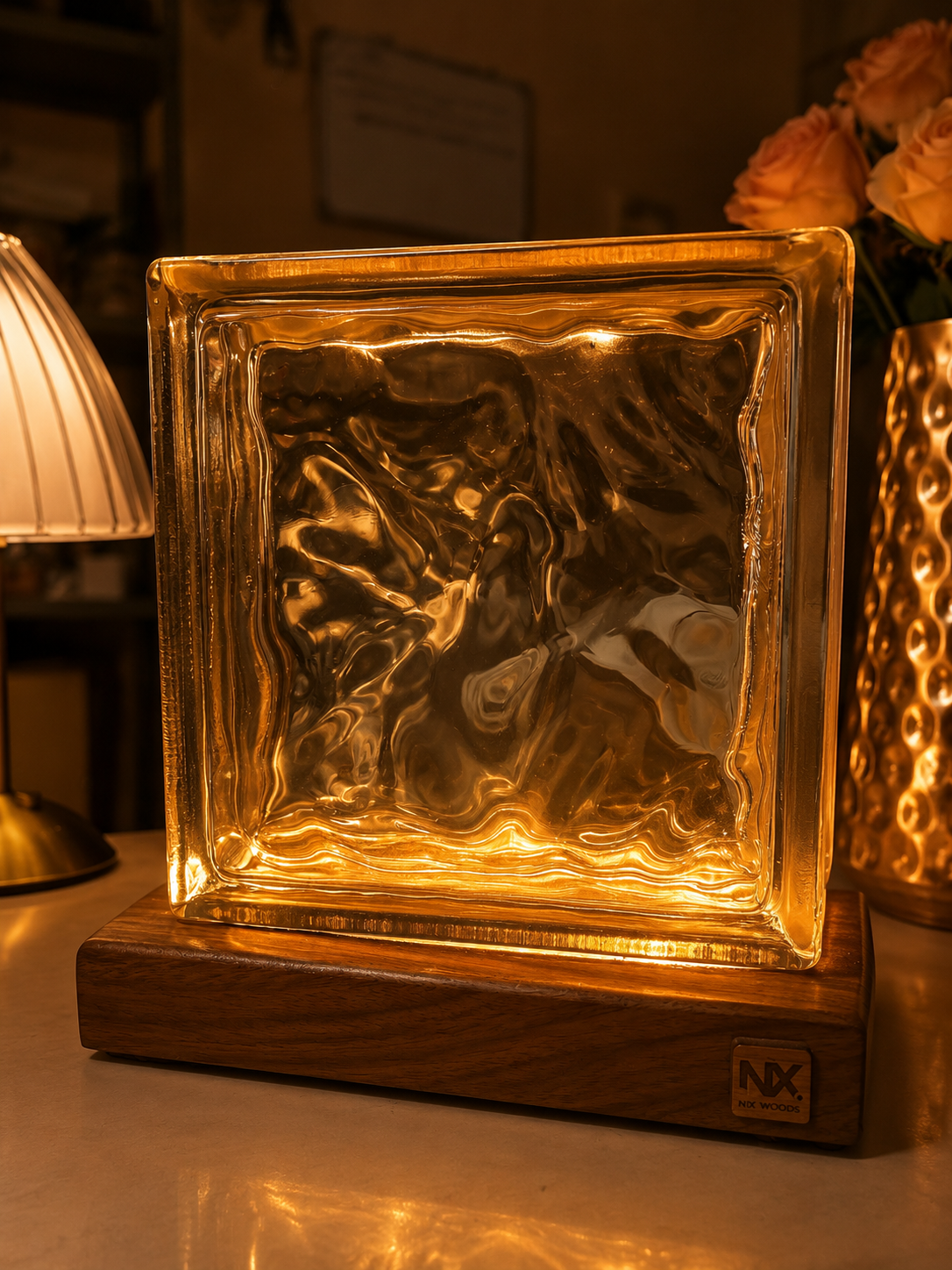 NixWoods Ocean Glass Rubik's Cube lamp glowing warm amber on a solid Sheesham wood base