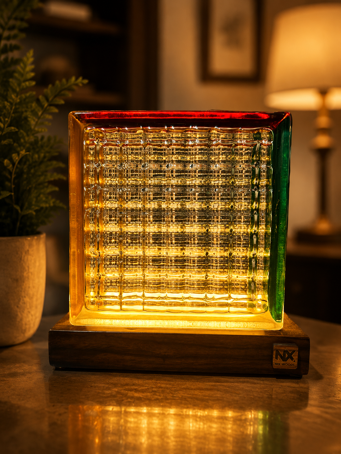 NixWoods Rubik's Cube table lamp glowing red, amber and green across its faces on a solid Sheesham wood base — turn the block to change colour