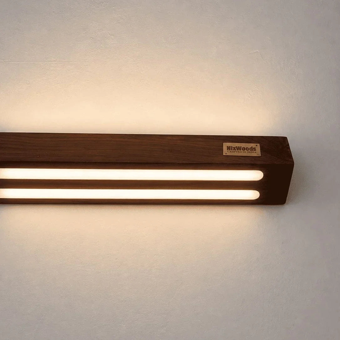 Close view of the rosewood wall lamp's twin warm LED channels and NixWoods badge - wooden wall sconce