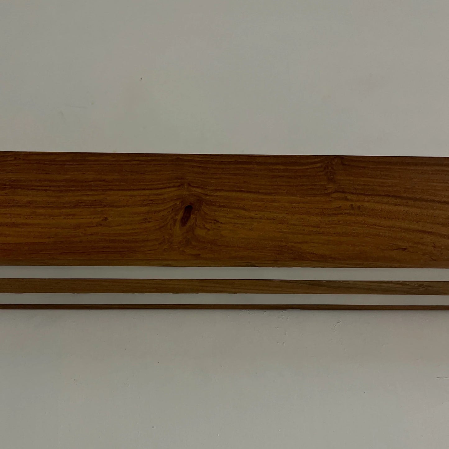 Close detail of the solid rosewood grain on the NixWoods wall lamp body - wooden wall light