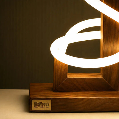 Rosewood base of the sculptural floor lamp with the NixWoods Crafted in India brass plate