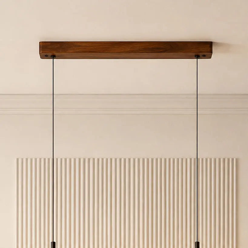 Teak ceiling canopy close-up with twin black suspension cables against a fluted wall