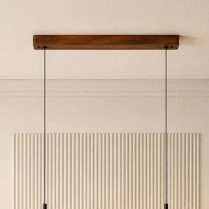 Teak ceiling canopy close-up with twin black suspension cables against a fluted wall