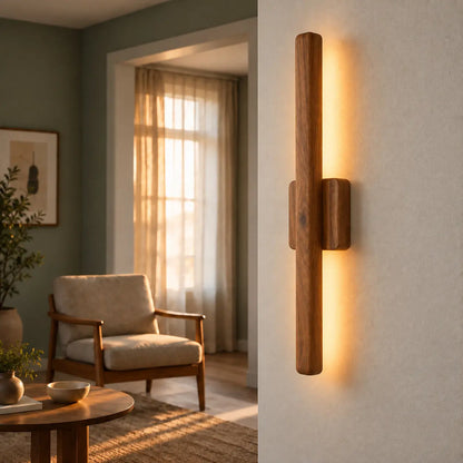 30-inch vertical wooden wall sconce lit in a green living room beside an armchair, NixWoods