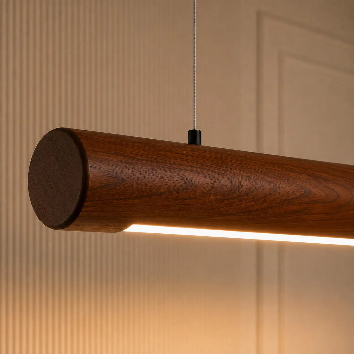 Close-up of the rounded rosewood end cap and grain on the cylindrical pendant with cable