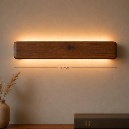 Arden 12-inch rosewood wall light with its length marked, warm LED glow — NixWoods