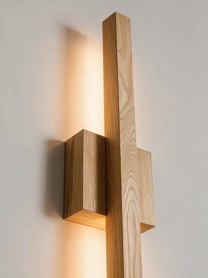 Wooden wall sconce detail showing wood grain and precision joinery at 45 degree angle