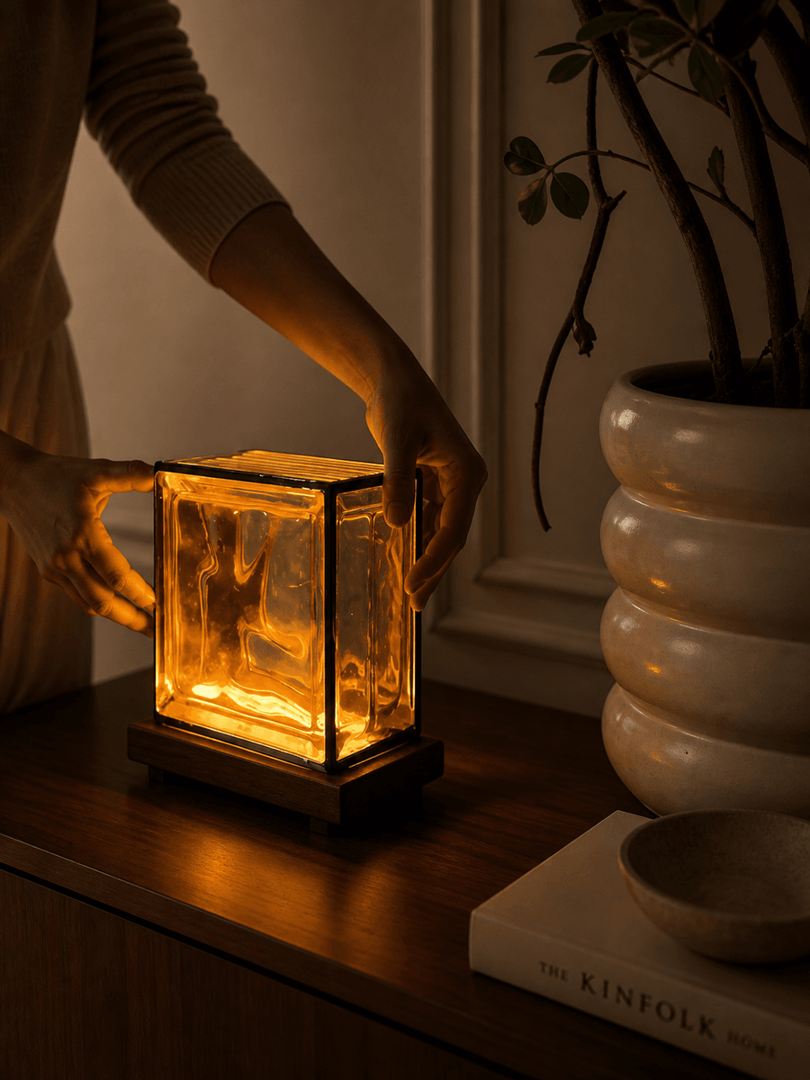 Hands placing the lamp on its solid Sheesham base