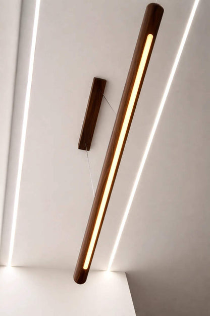 Scandinavian rosewood pendant lamp illuminating a wooden dining table with soft warm light