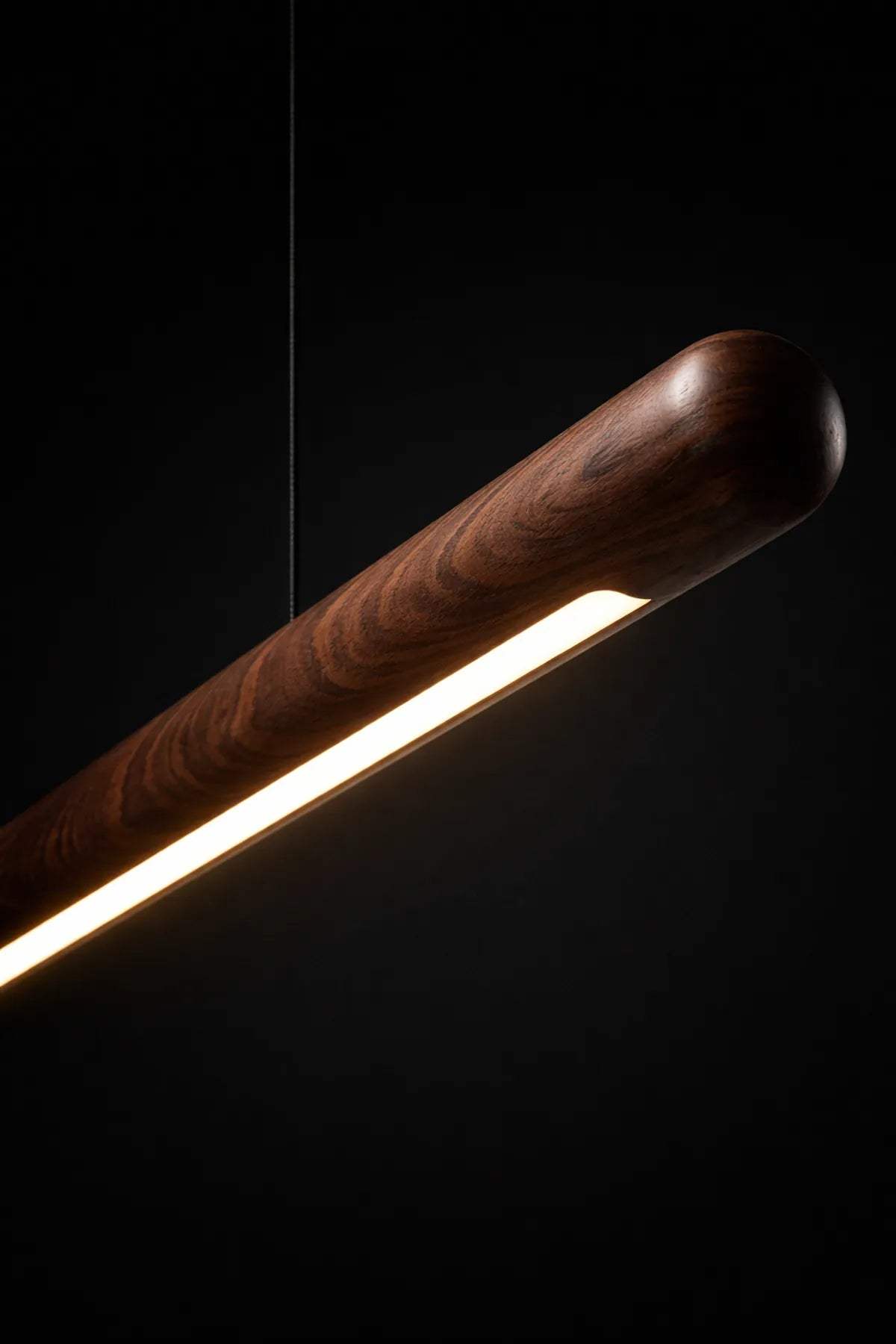 Scandinavian rosewood pendant light styled above a cozy living room seating area