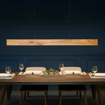Pine wood linear pendant light above a set dining table - NixWoods handcrafted hanging light