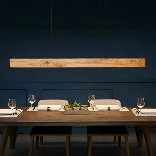 Pine wood linear pendant light above a set dining table - NixWoods handcrafted hanging light