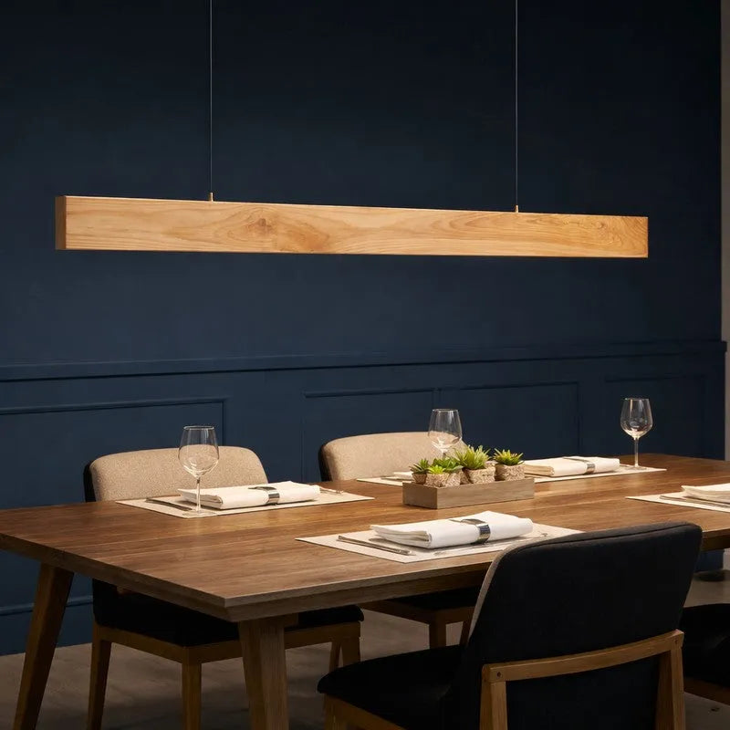 Pine wood pendant light above a wooden dining table and chairs - NixWoods linear hanging light